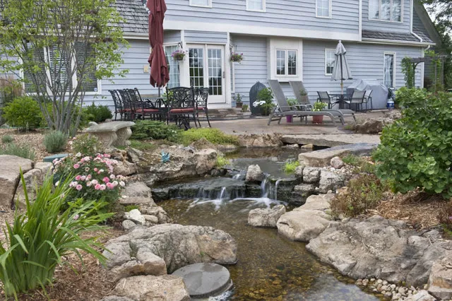 A smaller waterfall flows away from the patio