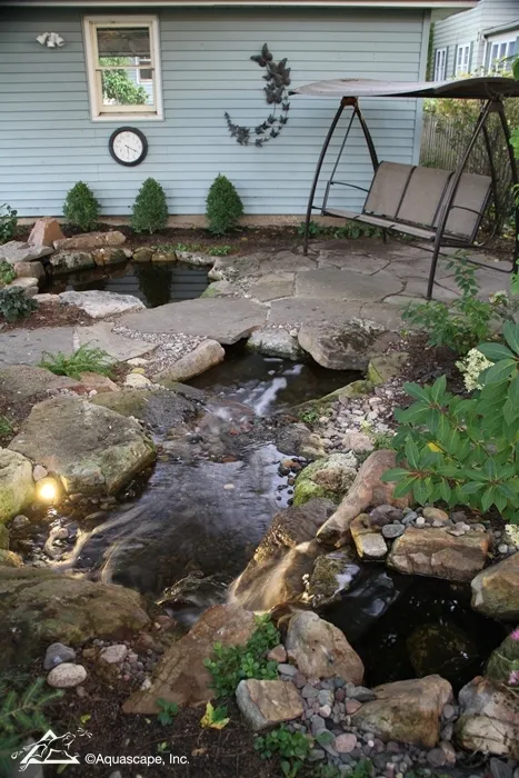 Beautiful Backyards often include a pond or water garden with a seating area.