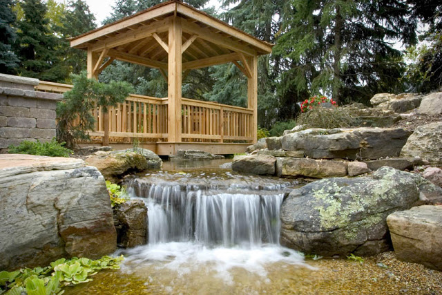 Who wouldn't love this floating deck overlooking a waterfall that cascades into a pebble beach?