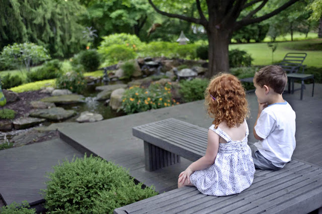 Kids always seem to have the right idea ... relaxing around the water feature from their day of play.