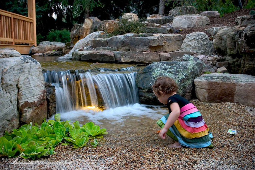 Child Playing in Pondless Waterfall