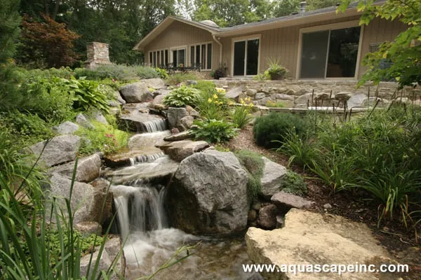 The upper falls and pond in this backyard cascade into another waterfall, taking advantage of the natural slope.