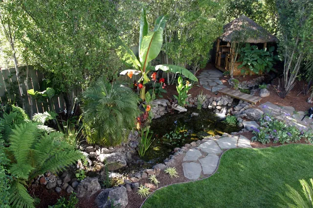 tikki-type gazebo provides great view of this pond and waterfall
