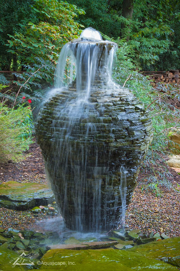 A stacked slate fountain urn becomes architecture in the garden.