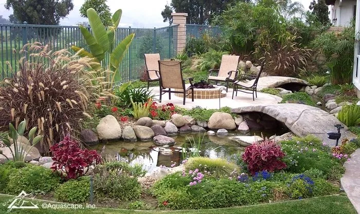 Backyard Pond with Bridge to Fire Pit