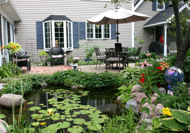 Enjoying a meal on this patio beside the pond is like being on vacation, dining in the tropics.