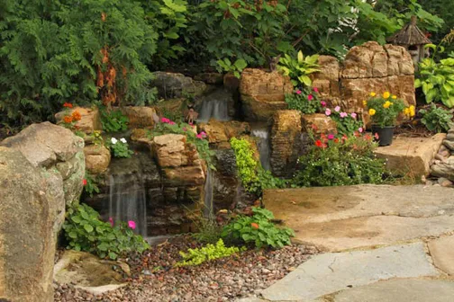 A re-circulating pondless waterfall. A sub-surface reservoir holds water that is repeatedly turned over the falls, conserving on the use of water in the landscape.