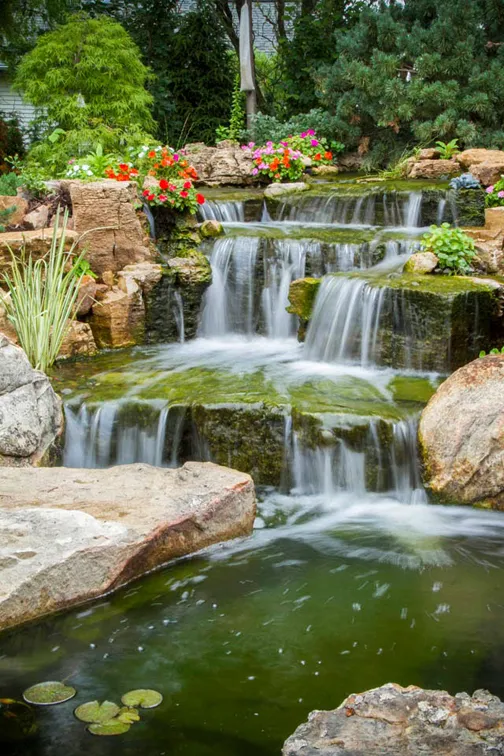 A close-up view reveals an aged appearance to the waterfalls, even though this water feature is brand new.