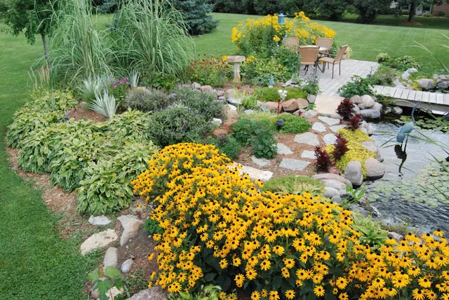 Another view reveals attractive plantings that transition the water garden to the expanse of grass beyond.