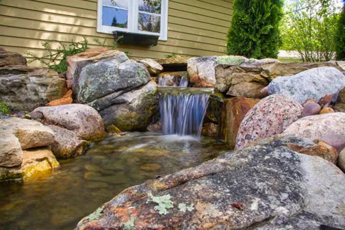 By using rocks of various shapes and sizes, this waterfall appears as though it has always been there.