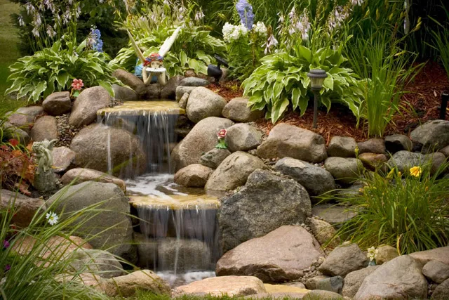 A bit of whimsy lends itself to this smaller waterfall. Imagine a child's delight upon discovering the tiny fairy.