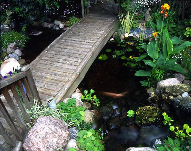 A well-worn bridge hints of many footfalls that traversed the peaceful stream over the years.