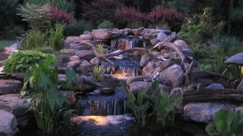 Beautiful nighttime waterfall setting! An eclectic Baltimore, MD Landscape design by Premier Ponds