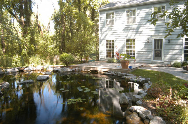 Here's a switch. This deck is at the front of the house with a beautiful, reflective pond to welcome visitors.