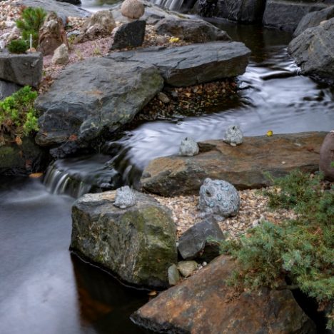 Aqua blue boulders in water feature